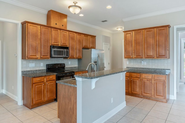 kitchen featuring light tile patterned flooring, decorative backsplash, appliances with stainless steel finishes, and an island with sink