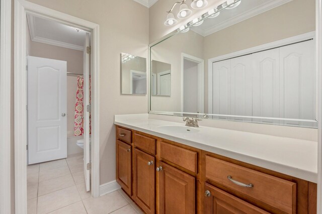 bathroom featuring vanity, ornamental molding, tile patterned flooring, and toilet