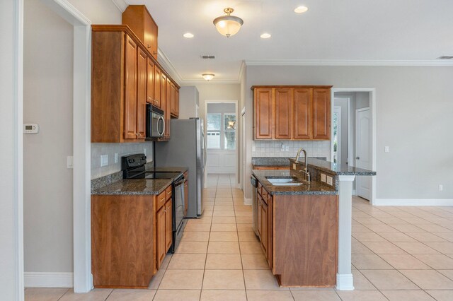 kitchen featuring decorative backsplash, sink, stainless steel appliances, and light tile patterned floors