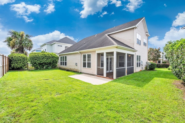 back of house featuring a sunroom and a lawn