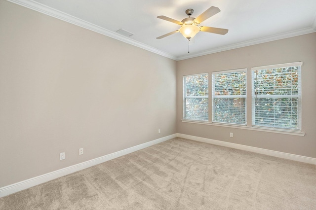 spare room featuring ceiling fan, ornamental molding, and light colored carpet