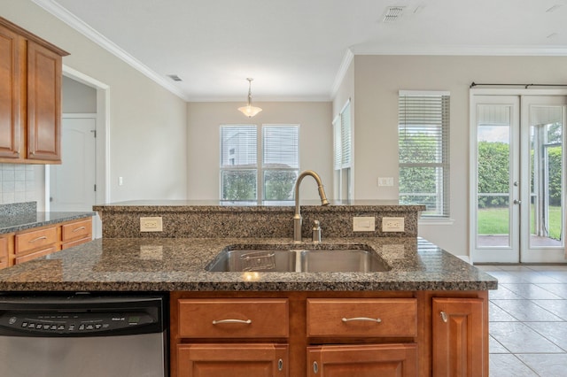 kitchen featuring ornamental molding, sink, dark stone countertops, dishwasher, and light tile patterned floors