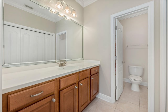 bathroom with tile patterned floors, vanity, ornamental molding, and toilet