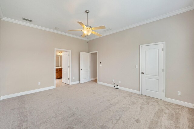 unfurnished bedroom with crown molding, ceiling fan, connected bathroom, and light colored carpet