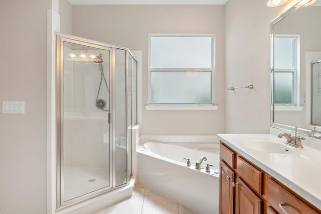 bathroom with tile patterned floors, vanity, and separate shower and tub