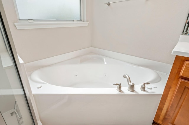 bathroom featuring a tub and vanity