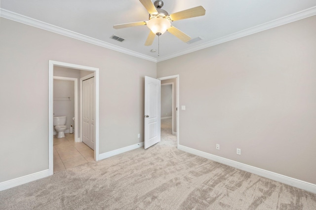 unfurnished bedroom featuring ensuite bathroom, light carpet, ornamental molding, and ceiling fan