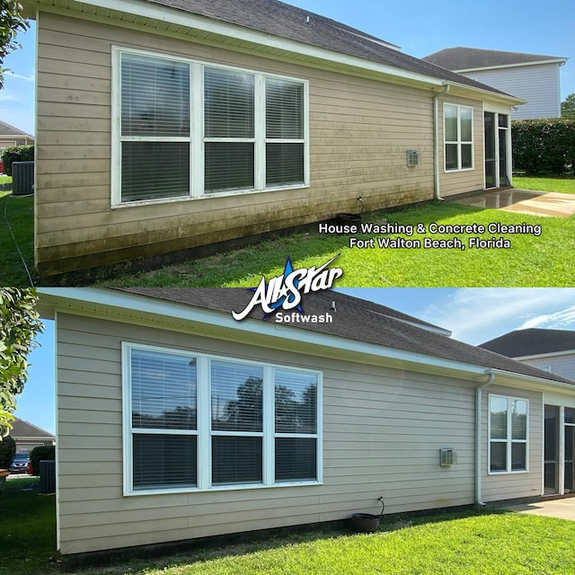 rear view of property with cooling unit and a lawn