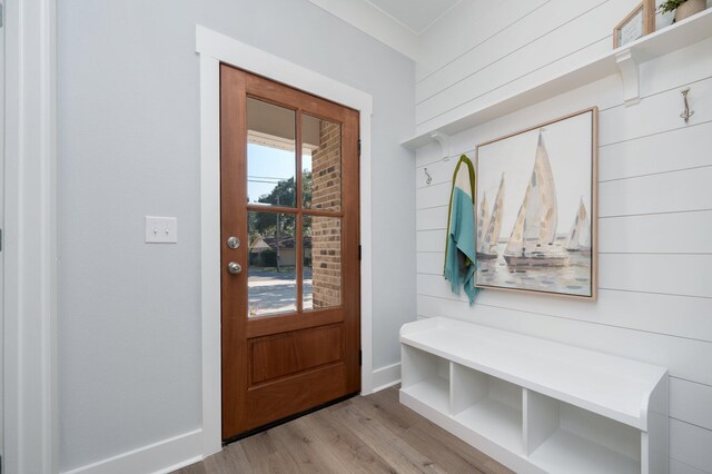 mudroom with wooden walls, baseboards, and wood finished floors