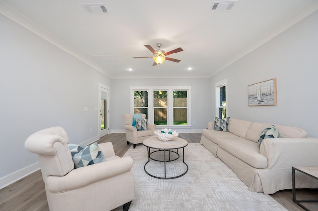 living area featuring visible vents, baseboards, and wood finished floors