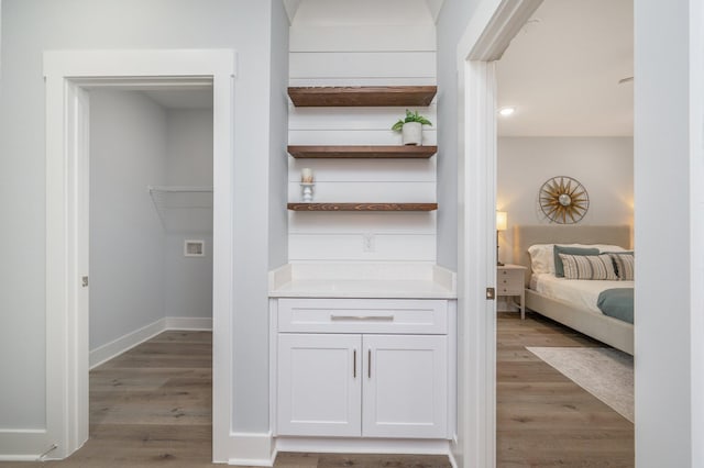 interior space featuring baseboards and wood finished floors