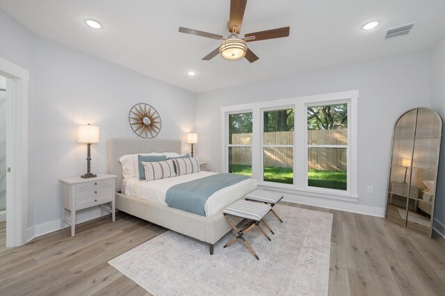 bedroom featuring wood finished floors, visible vents, and recessed lighting