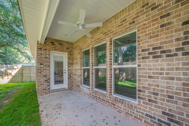 view of patio / terrace with fence and a ceiling fan