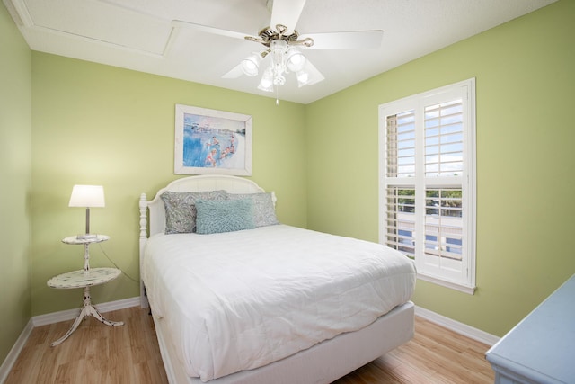 bedroom with ceiling fan and light hardwood / wood-style flooring