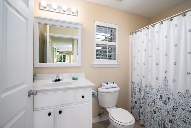 bathroom featuring vanity, a textured ceiling, toilet, and tile patterned flooring