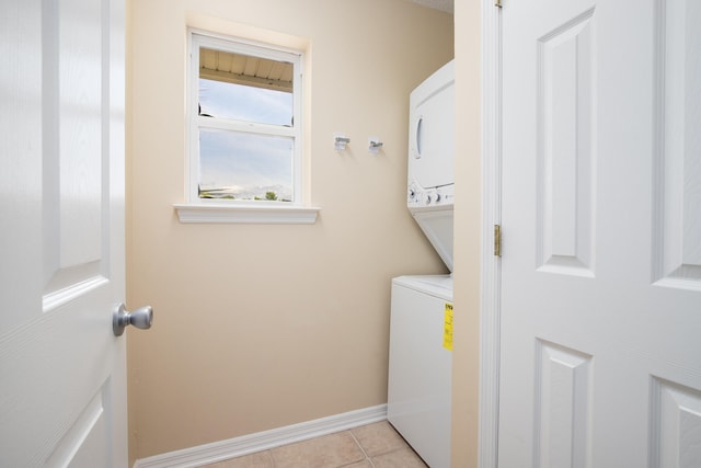 washroom with light tile patterned floors and stacked washer and dryer