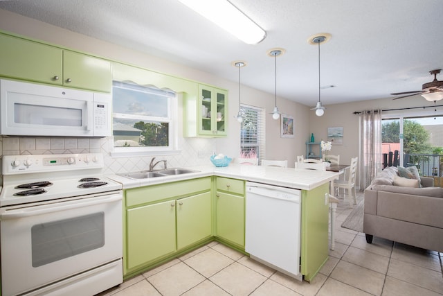 kitchen featuring ceiling fan, plenty of natural light, kitchen peninsula, and white appliances