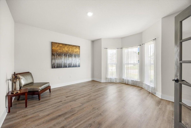 sitting room with hardwood / wood-style flooring