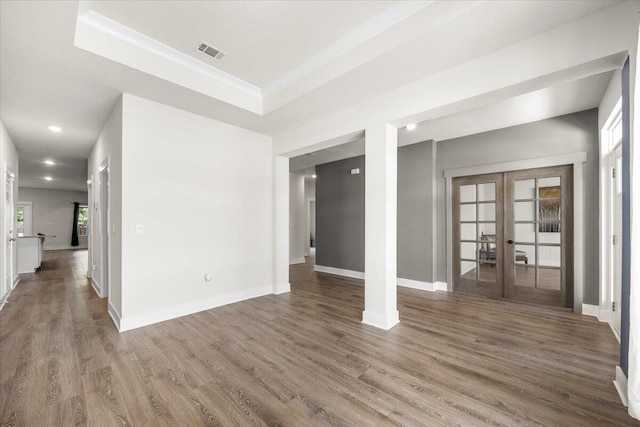 unfurnished room with french doors, hardwood / wood-style floors, and a tray ceiling