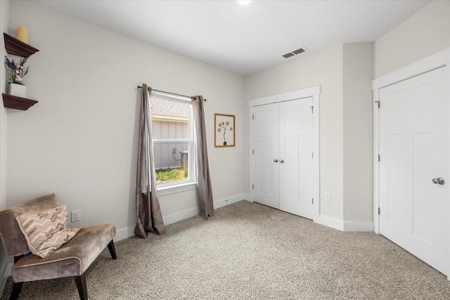 living area with light colored carpet