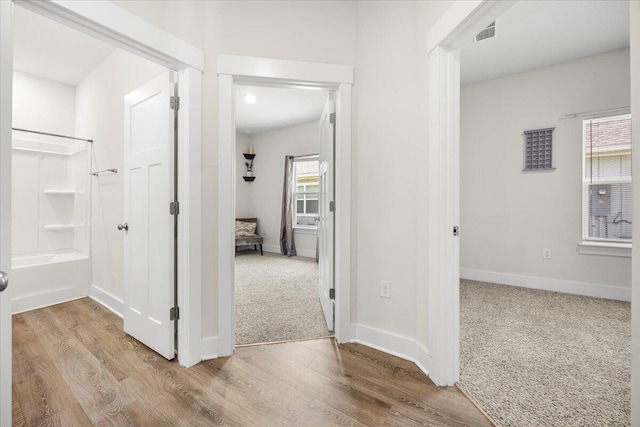 corridor with light hardwood / wood-style flooring