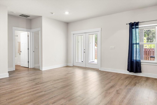 foyer entrance featuring wood-type flooring and a healthy amount of sunlight