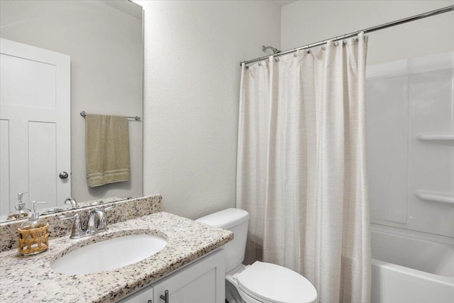 full bathroom featuring vanity, shower / bath combo with shower curtain, and toilet