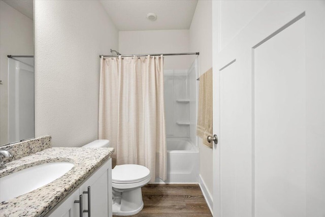 full bathroom with vanity, wood-type flooring, toilet, and shower / tub combo