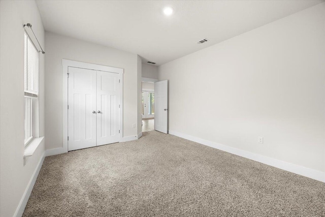 unfurnished bedroom featuring a closet and carpet flooring