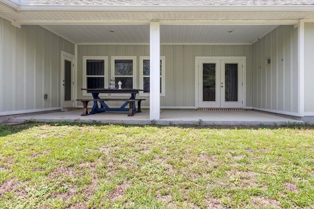 view of exterior entry featuring a lawn