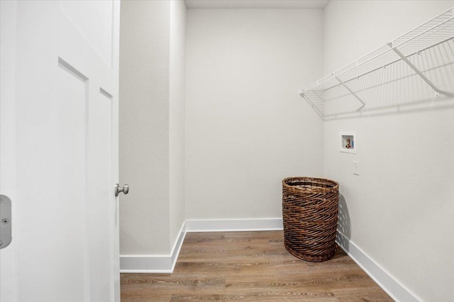 laundry area featuring washer hookup and hardwood / wood-style floors