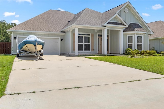 view of front of property featuring a garage and a front lawn