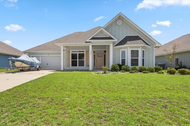 view of front of house with a garage and a front lawn