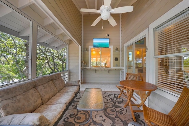 sunroom with wooden ceiling and ceiling fan