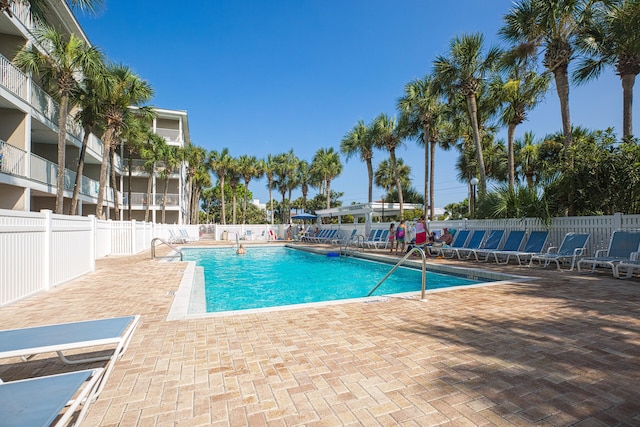 pool featuring a patio area and fence