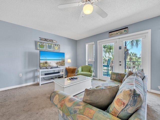 living room featuring baseboards, a ceiling fan, light colored carpet, a textured ceiling, and french doors