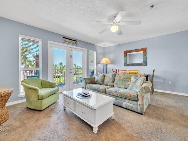 living area with baseboards, french doors, and light colored carpet