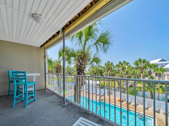 balcony with ceiling fan and a water view