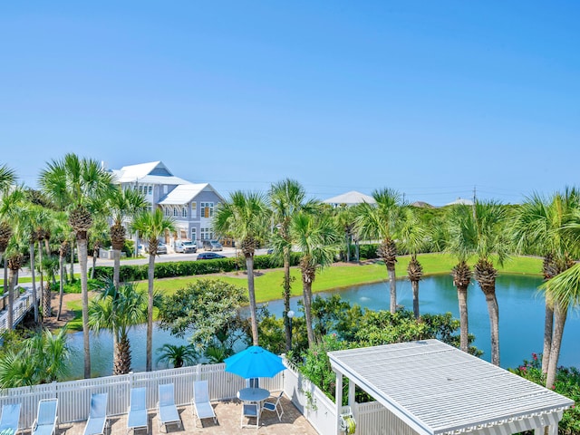 dock area featuring a water view, fence, and a pergola