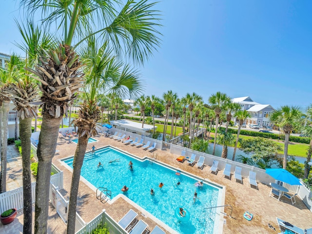 community pool featuring a patio area and fence