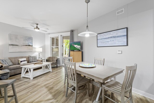 dining room with ceiling fan and light wood-type flooring