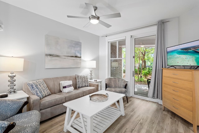 living room featuring light hardwood / wood-style floors and ceiling fan