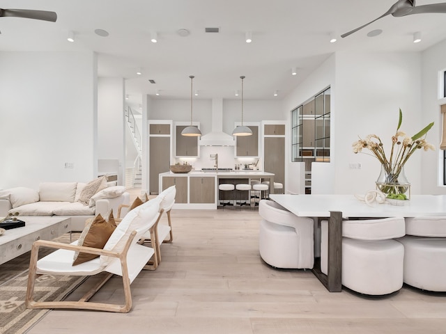 living room with light hardwood / wood-style flooring and sink