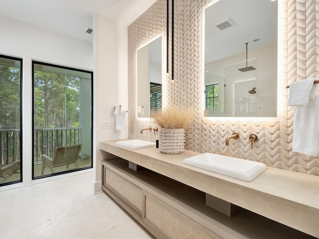 bathroom with walk in shower, vanity, backsplash, and tile patterned flooring