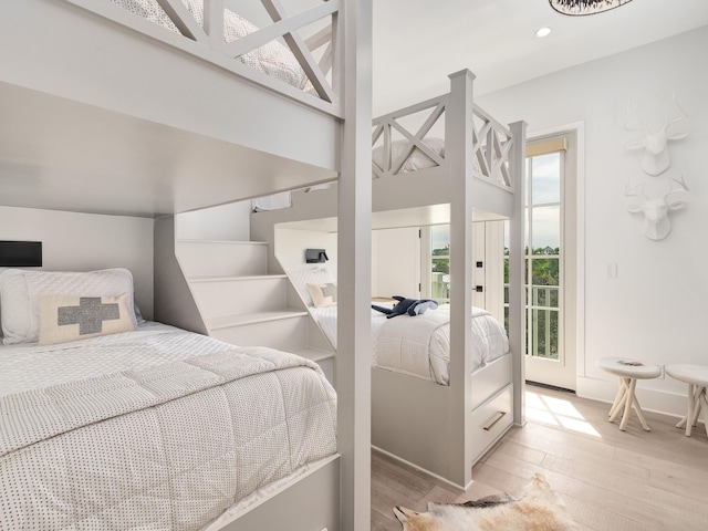 bedroom featuring light wood-type flooring and access to exterior