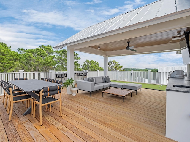 wooden terrace featuring outdoor lounge area, area for grilling, and ceiling fan