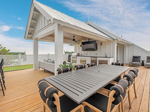 wooden deck with an outdoor hangout area and ceiling fan