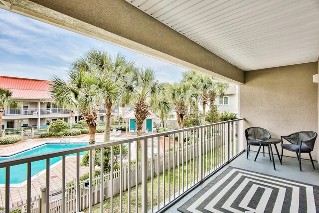 balcony with a fenced in pool