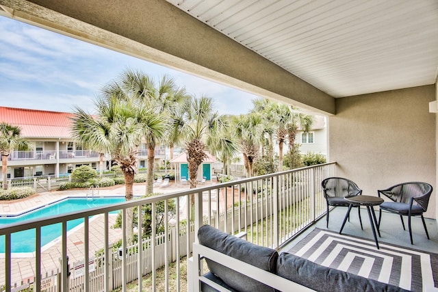 balcony with a fenced in pool