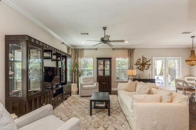 living room with crown molding, light wood-type flooring, and ceiling fan